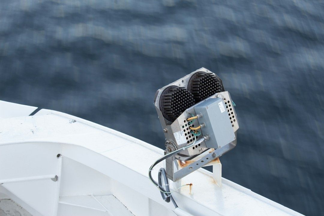 Hull-mounted sonar transducer above dark water