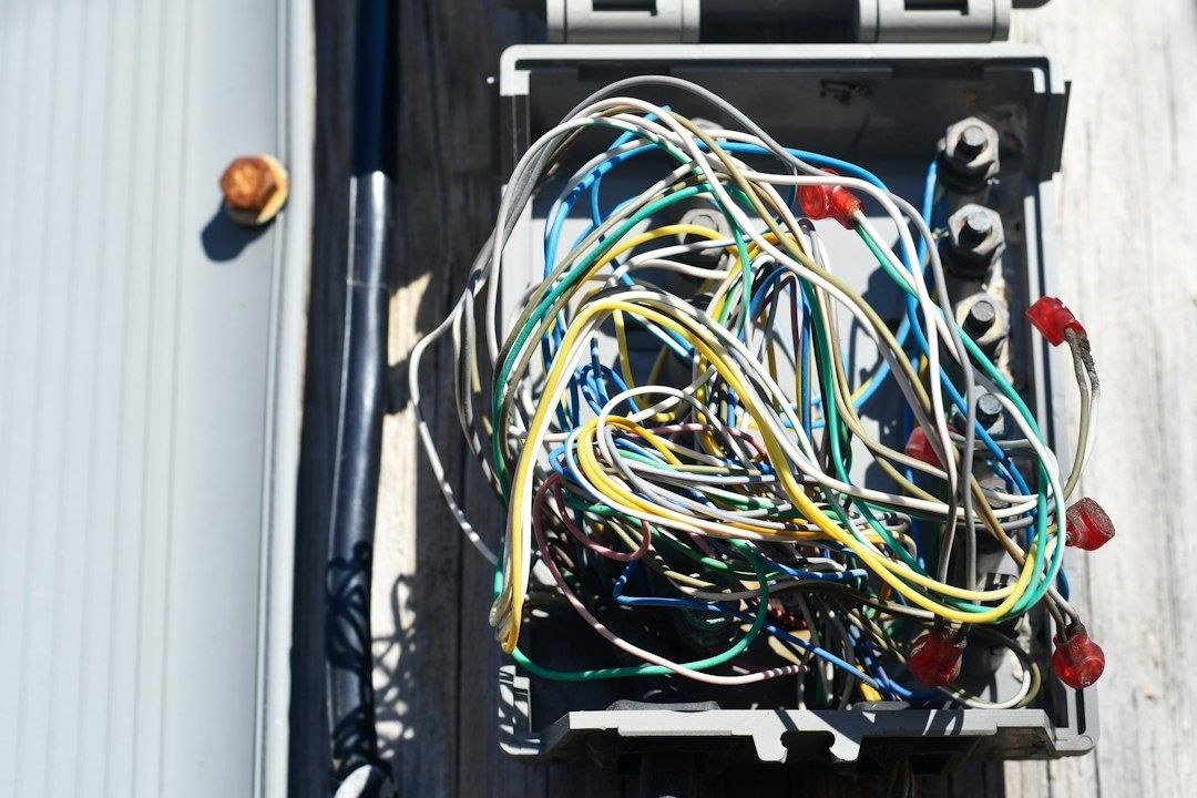 Open electrical panel with a tangled bundle of multicolored wires